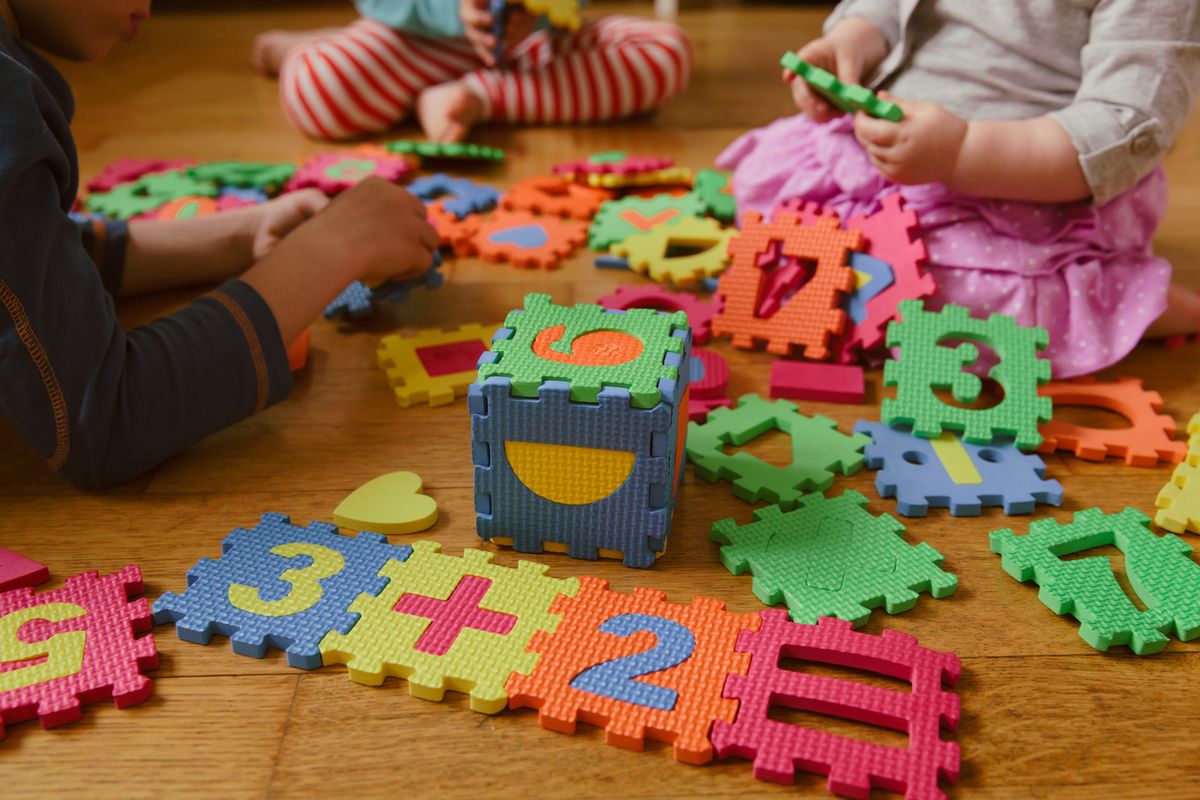 Young children playing with a number puzzle