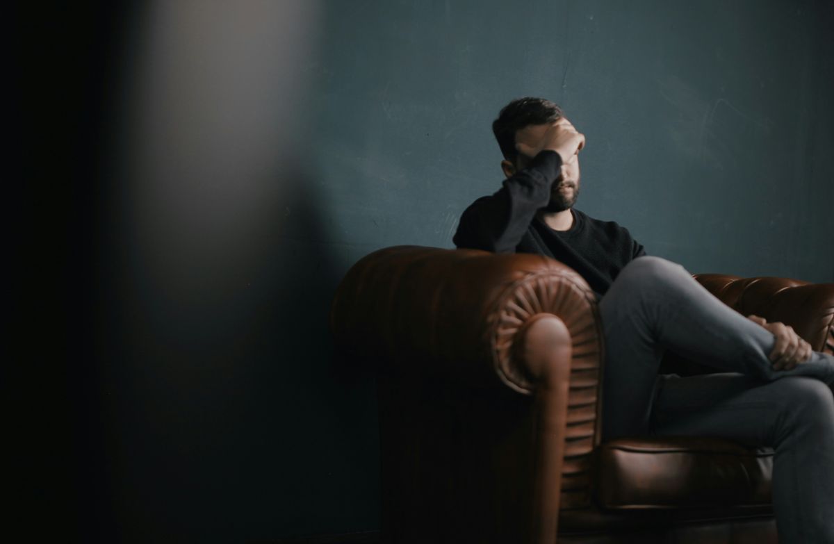 A depressed man on a sofa