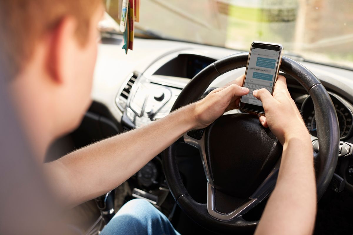 Young man on his phone while driving