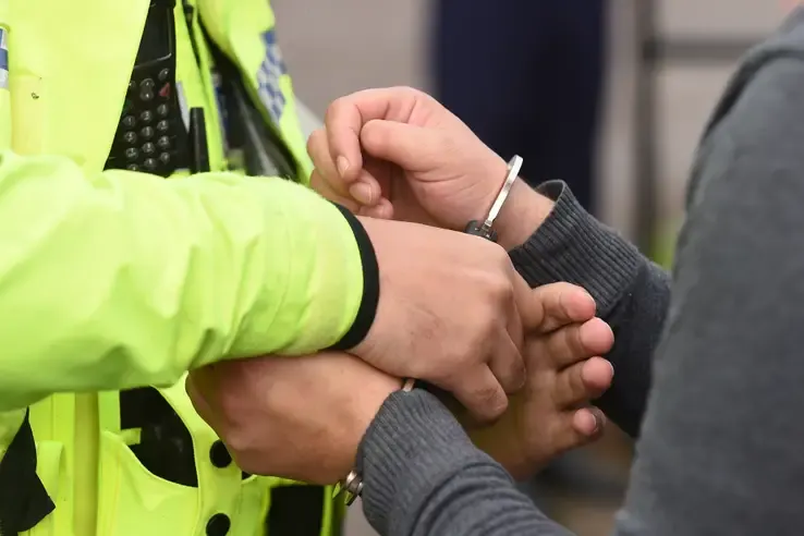 Young male being arrested by police