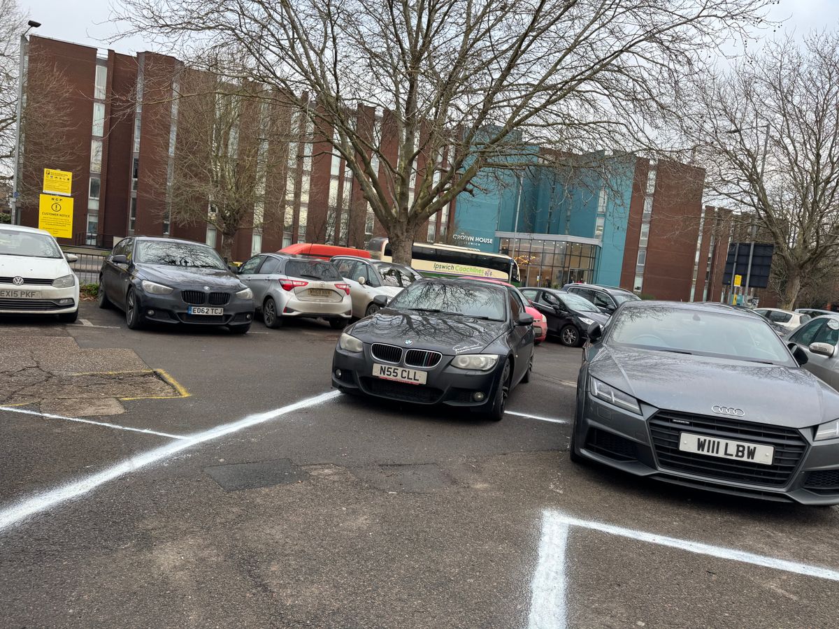 A badly parked black BMW at Tower Ramparts car park in Ipswich