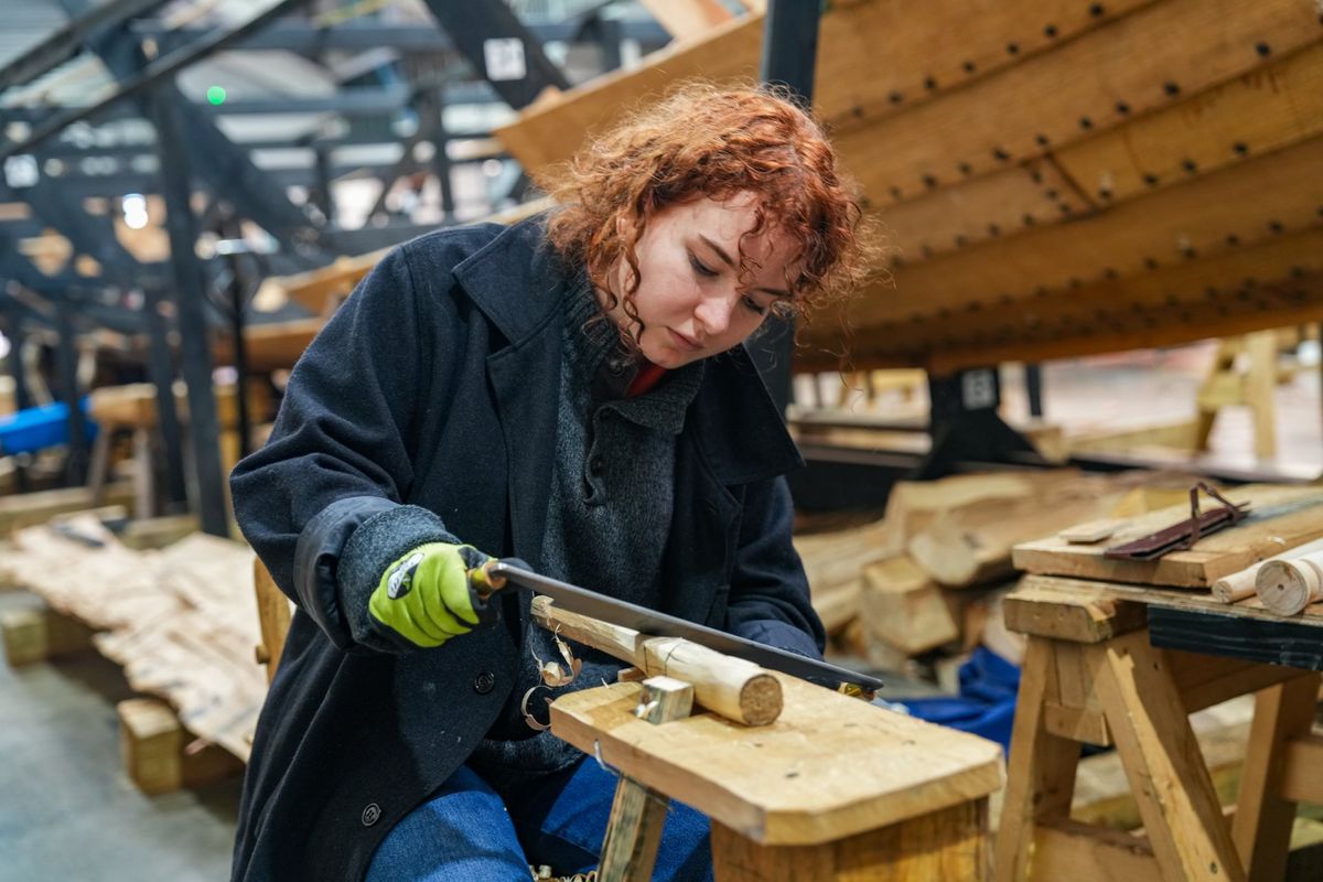 A volunteer building a Viking long boat similar to the ship discovered across the River Deben at Sutton Hoo