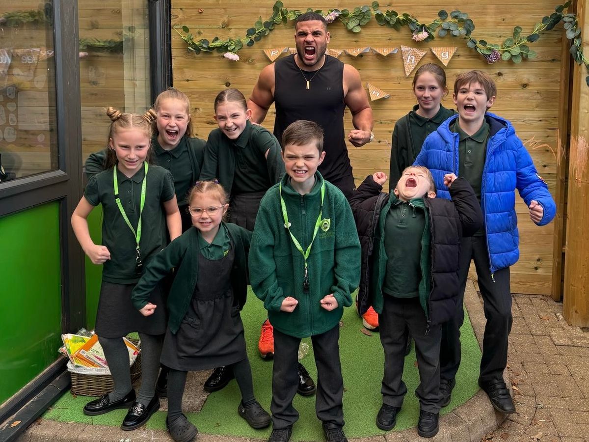 Gladiator Steel posing with students at Gusford Primary School