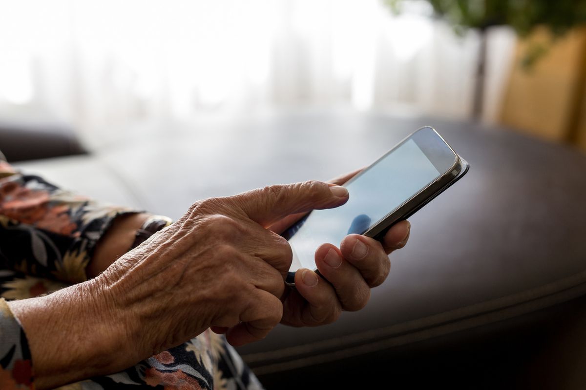 An old woman using her mobile phone