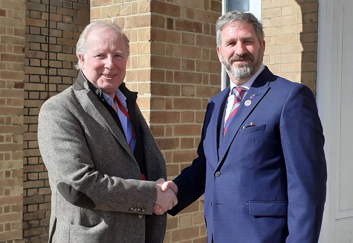 Outgoing Suffolk Armed Forces Commissioner Lee Holloway, left, welcomes his successor Andy Smith into his new role
