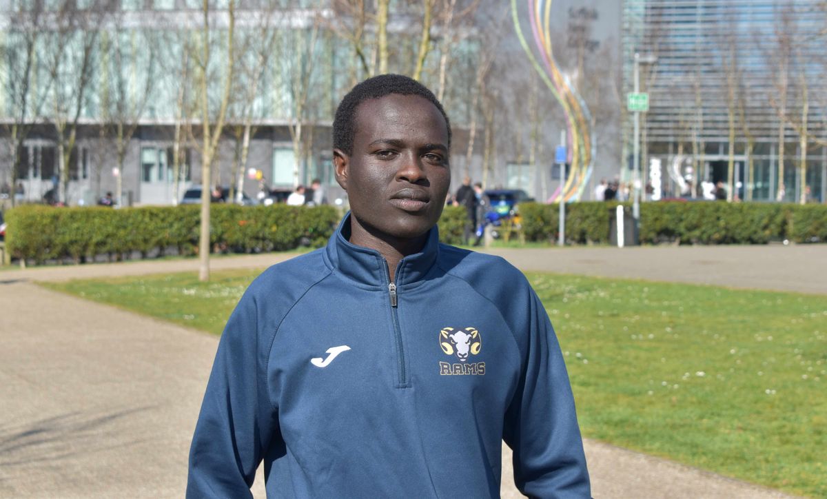 Osman in his training kit outside the college