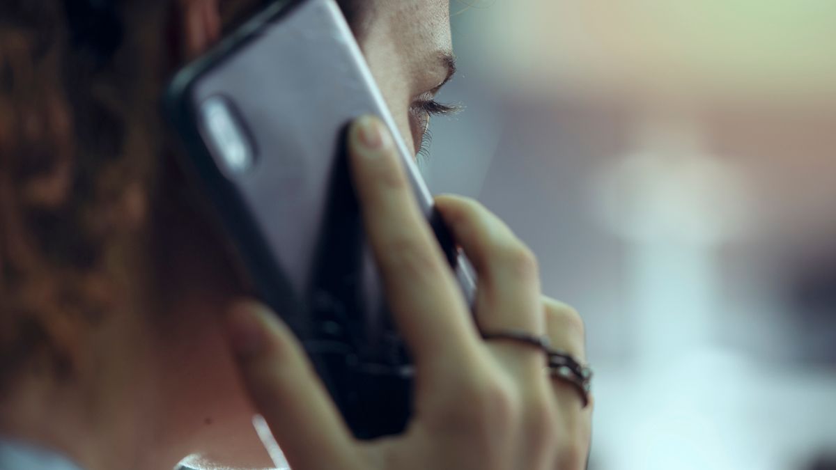 A woman holding a phone to her ear