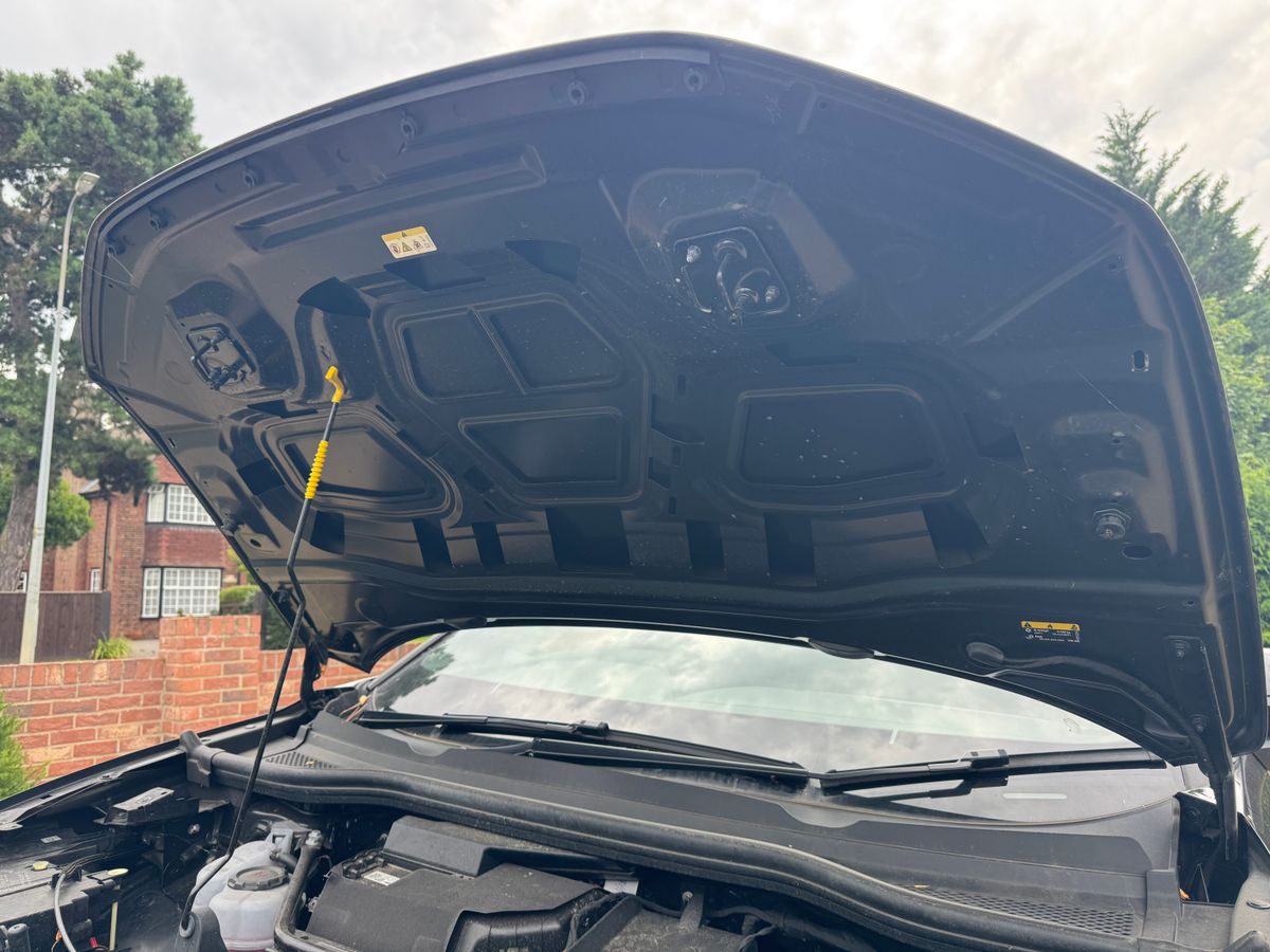 A black car with its bonnet open