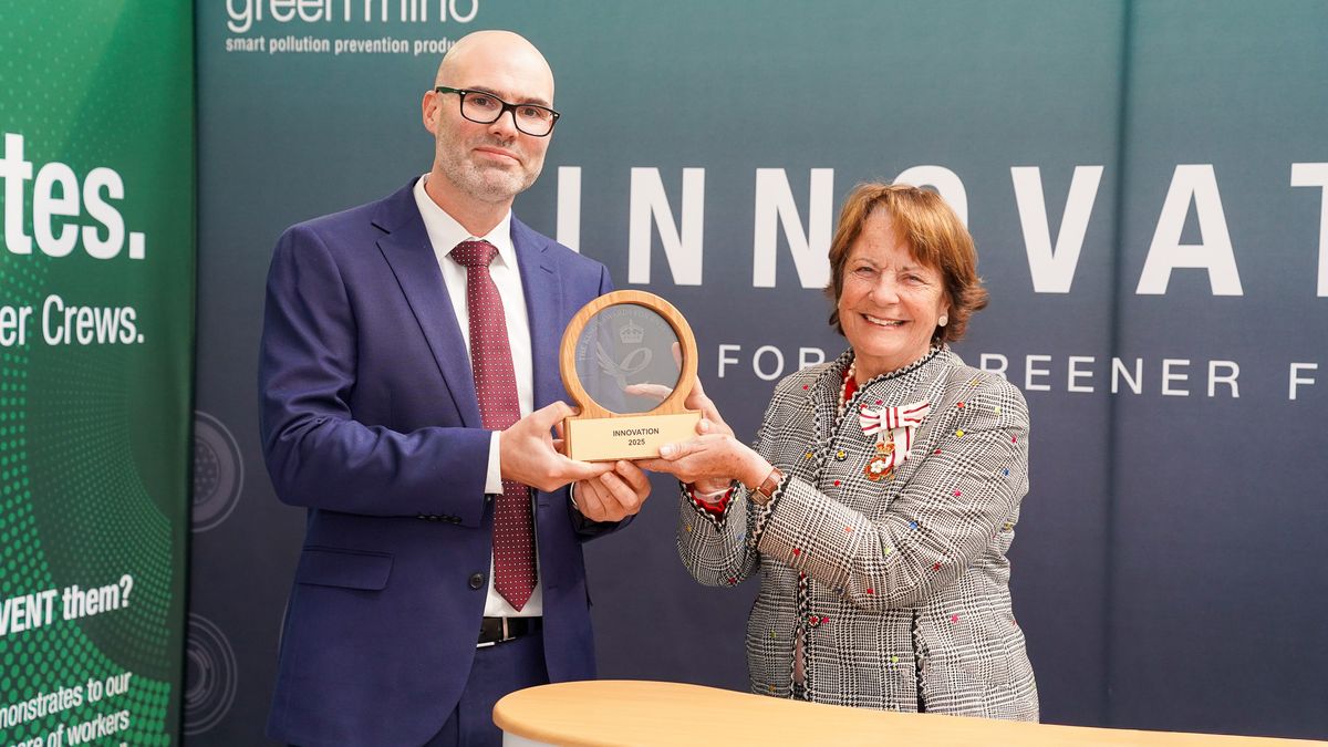 Two people with award