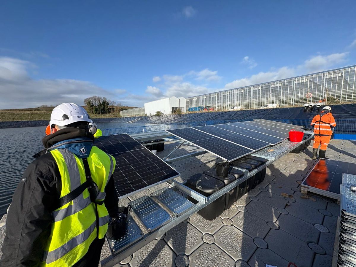 Workers in the early stages of installing the UK's largest solar pontoon at Fresh Suffolk in Bramford