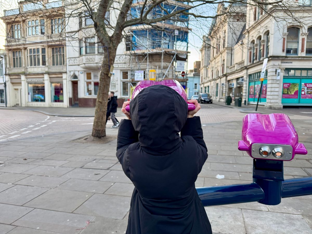 A young girl looking into the past at the Buttermarket