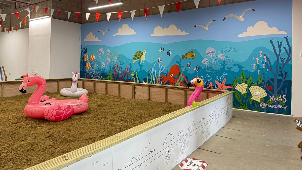 Local artist unveils mural at Buttermarket's indoor beach