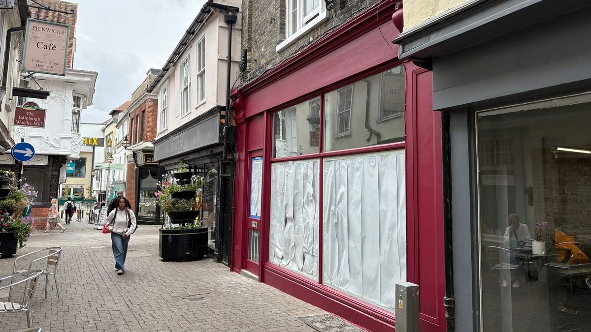 Hot pink shopfront repainted after council steps in