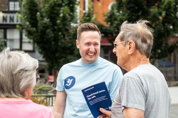 Oliver Rouane-Williams speaking with an elderly couple in the town centre