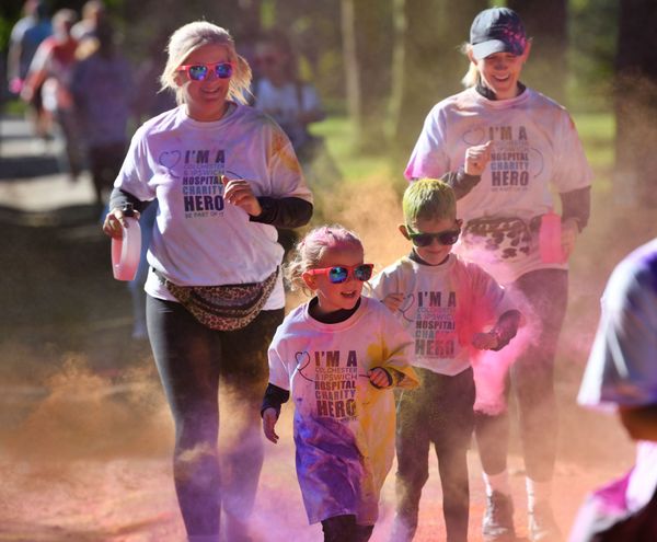 Two adults and two children take part in the colour run