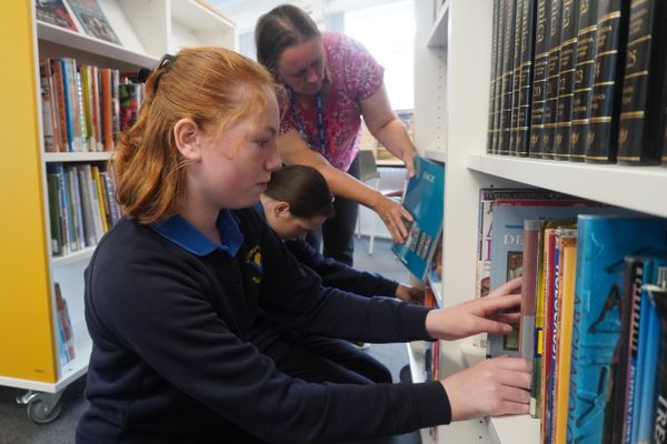 Stowupland High School’s library technicians grab a book to read in the school’s new library space