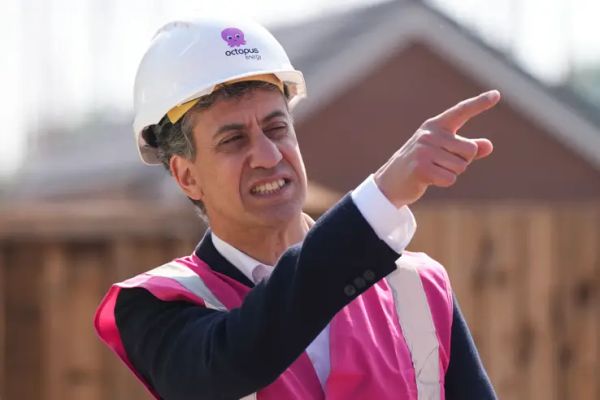 Ed Milliband in a pink hi-vis jacket and hard hat