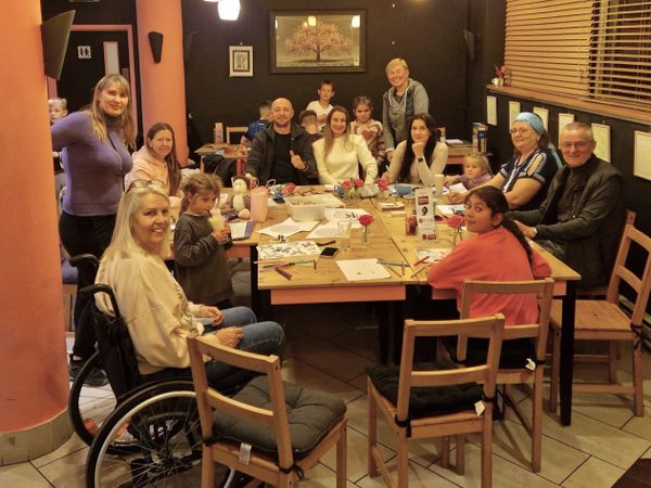People gather at the Ukrainian Wellbeing Café at On the Huh Café in Ipswich