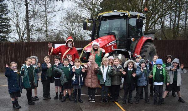 Children from the primary school at Witnesham get into the festive spirit with Farmer Christmas and his naughty elf helper