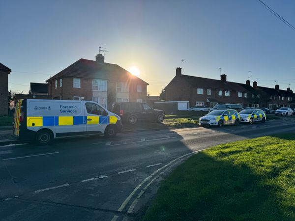 Two police cars and a forensics unit at an address on Hawthorn Drive, Ipswich