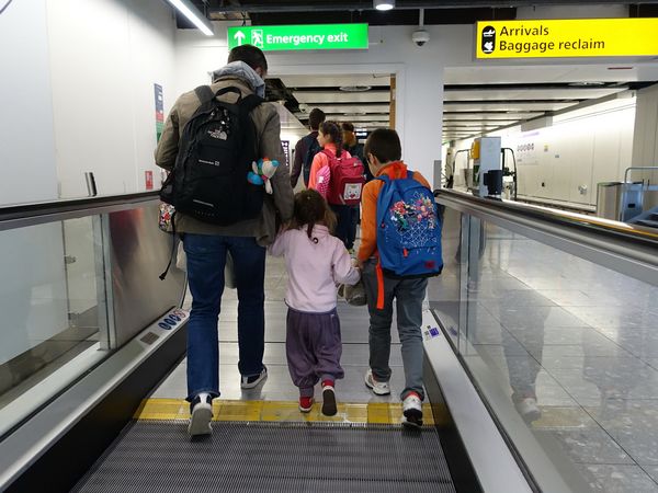 A father with his two children at an airport