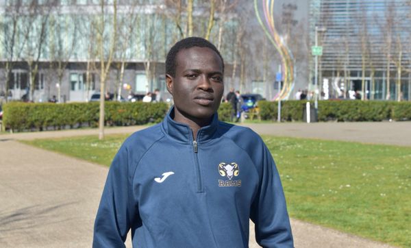 Osman in his training kit outside the college
