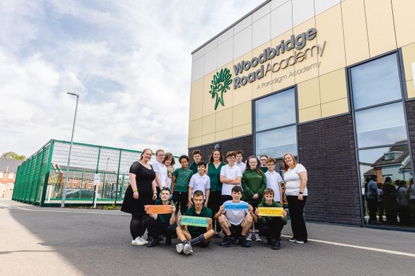 Staff and students celebrate outside Woodbridge Road Academy following it's first Oftsed report