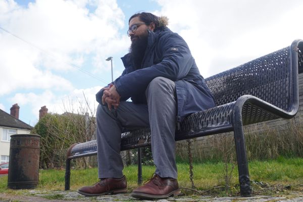 Rev'd Kiran Lotay AKA Hyrbrid sitting on a bench