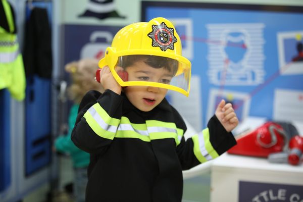 A young boy plays firefighters at Little City