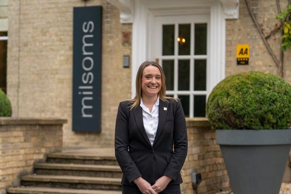 Woman happy in front of building