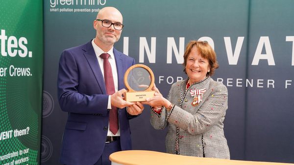 Two people with award