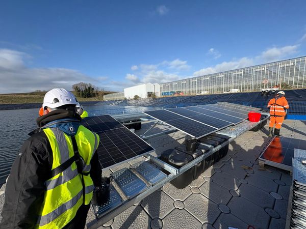 Workers in the early stages of installing the UK's largest solar pontoon at Fresh Suffolk in Bramford