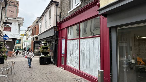 Hot pink shopfront repainted after council steps in
