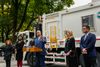 Mayor Eric Adams, DSNY Sanitation Commissioner Jessica Tisch, and others stand in front of a DSNY truck to announce a new rul