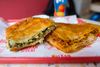 Spinach and cheese burek, $6.50, ground lamb and beef burek, $7.50, on a tray, for a closeup.
