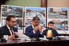 DOT Commissioner Ydanis Rodriguez gestures with his hands at a table in front of diagrams showing street improvements during