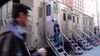 A staffer enters a silver movie trailer parked on a NYC block.