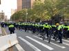 Members of the neon-clad SRG on bicycles behind 1 Police Plaza.