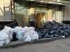 Trash and recycling bags line a sidewalk.