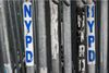 A police barricade with NYPD stickers.