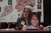 Amy Cohen testifies at a City Council hearing in 2014, holding a photo of her son Sammy, who was killed by a speeding van dri