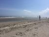 A sandy stretch of Rockaway Beach on a sunny day.