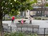 Two people play ping pong in the park.