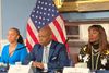 Eric Adams and senior staff sitting in front of an American flag in City Hall