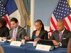 Eric Adams and staff sit at a table at City Hall during a press conference
