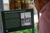 A person looks at a plaque about New York's municipal slave market.