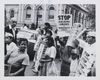 Civil rights protesters with the Congress of Racial Equality hold up signs that say "Stop housing abuses to minority groups"