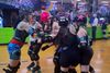 The Long Island Roller Rebels skating.