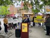 Brooklyn Councilmember Lincoln Rester stands at a podium in front of a group of street safety activists with Make McGuinness