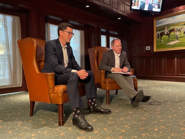 Claude Aiken and Drew Clark sitting in chairs